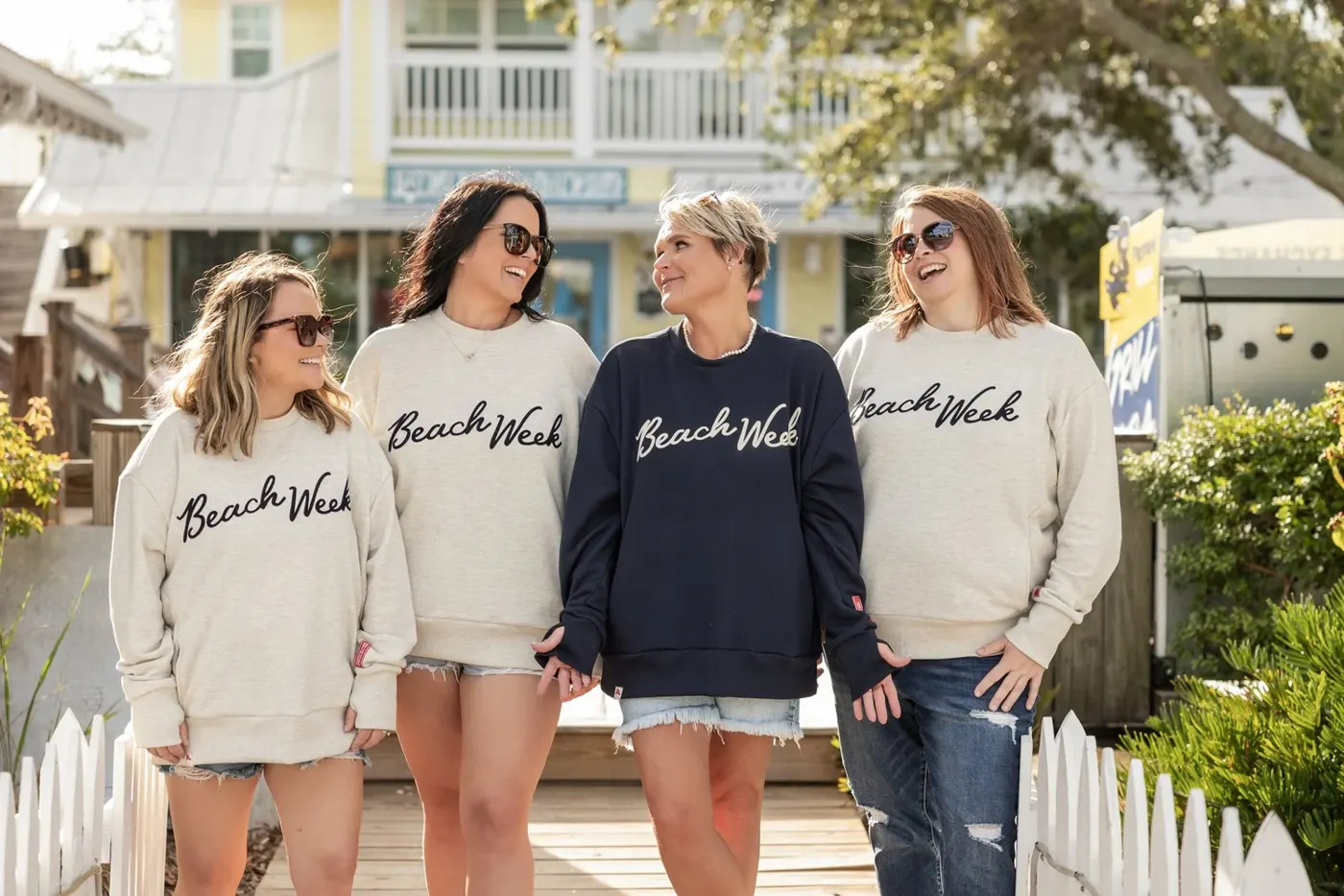 Beach Week Club clothing brand photoshoot with four women in branded sweatshirts