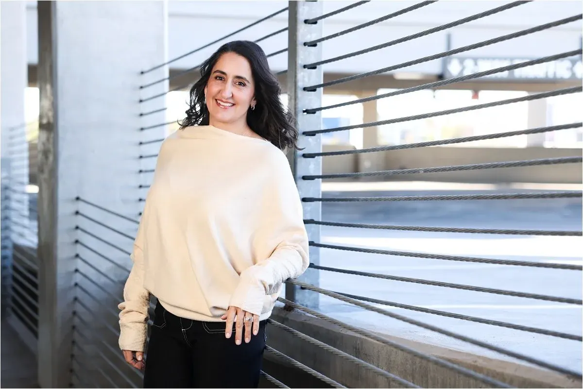 Outdoor headshot in a cream sweater