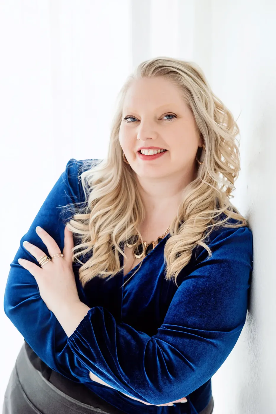 Headshot of a professional in a blue velvet blazer