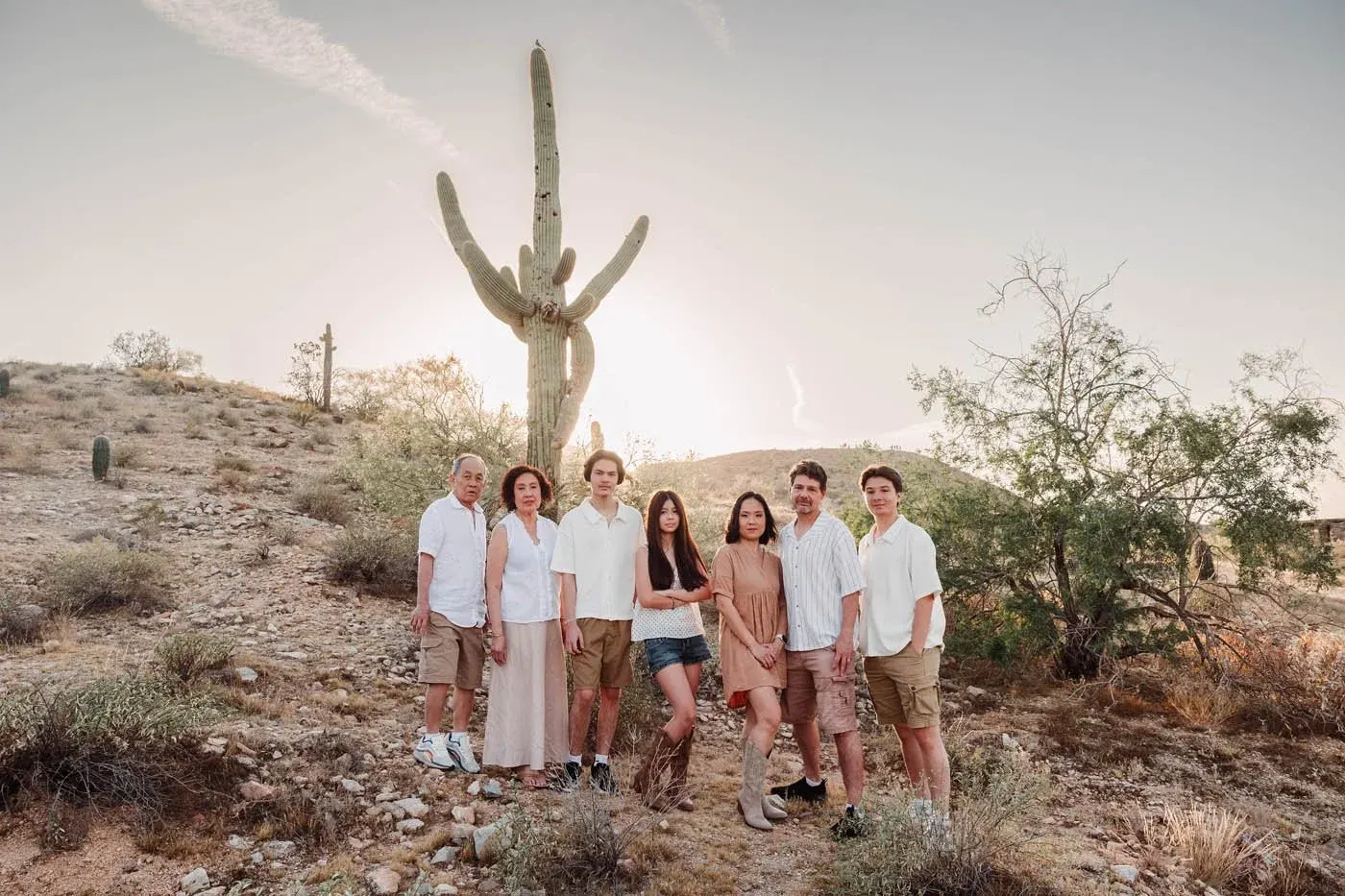Large family group beside a saguaro at sunset