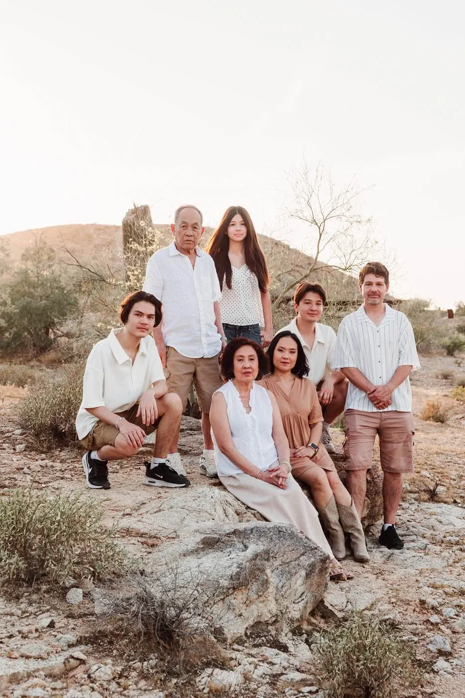 Family seated together on desert rocks at South Mountain