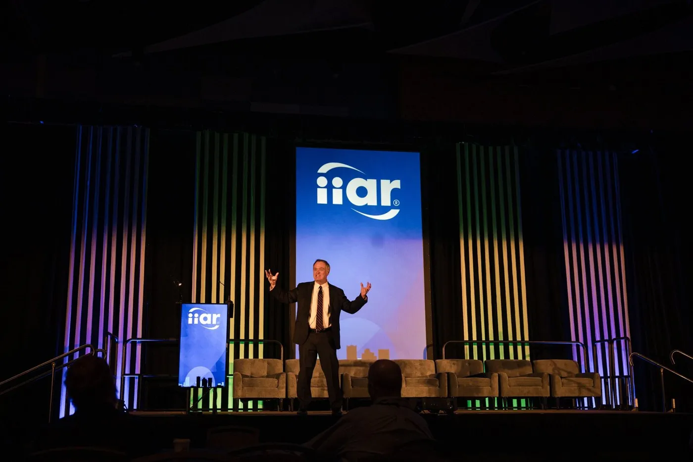 Conference keynote on a lit stage
