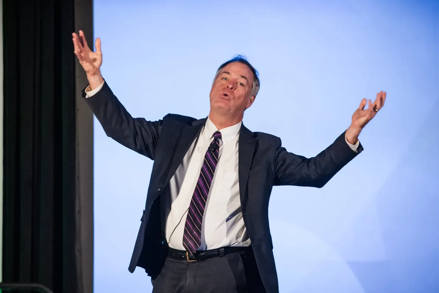 Keynote speaker photographed on stage at a Phoenix conference