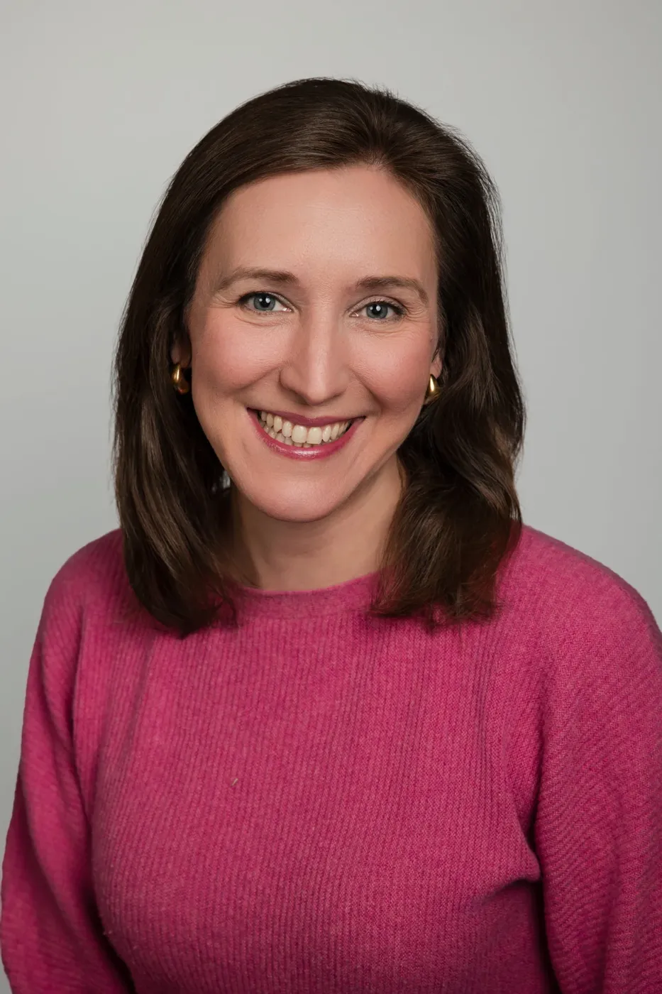 Corporate headshot on a gray backdrop
