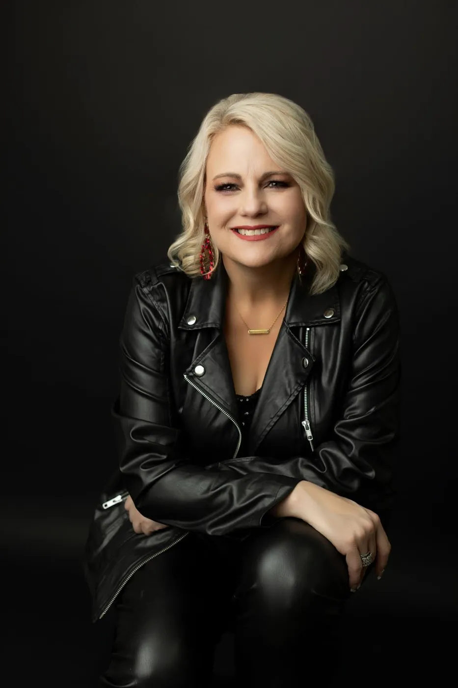 Studio branding portrait of a woman in a black leather jacket
