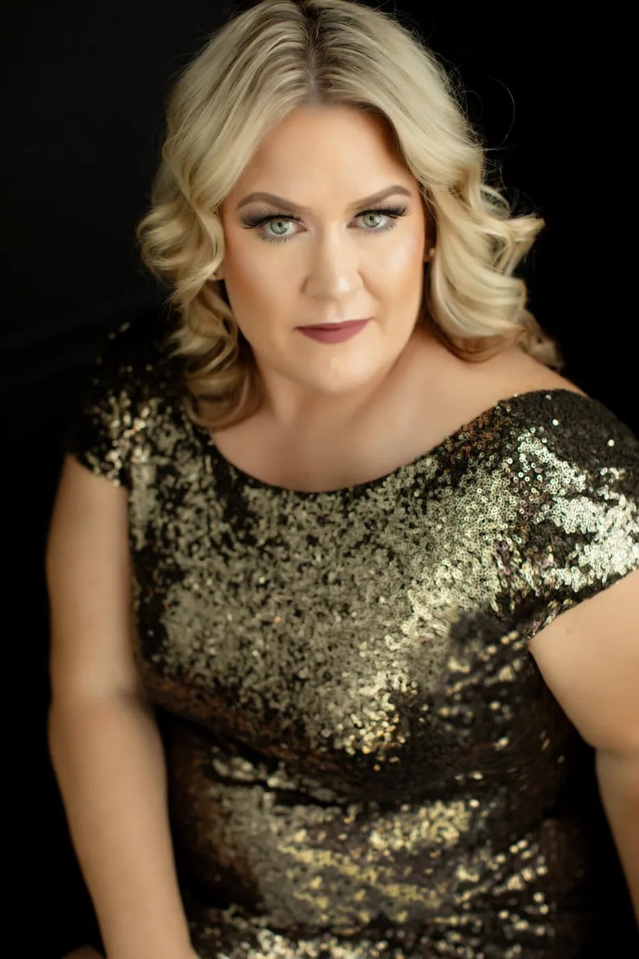 Glamour headshot of a woman in a gold sequin top