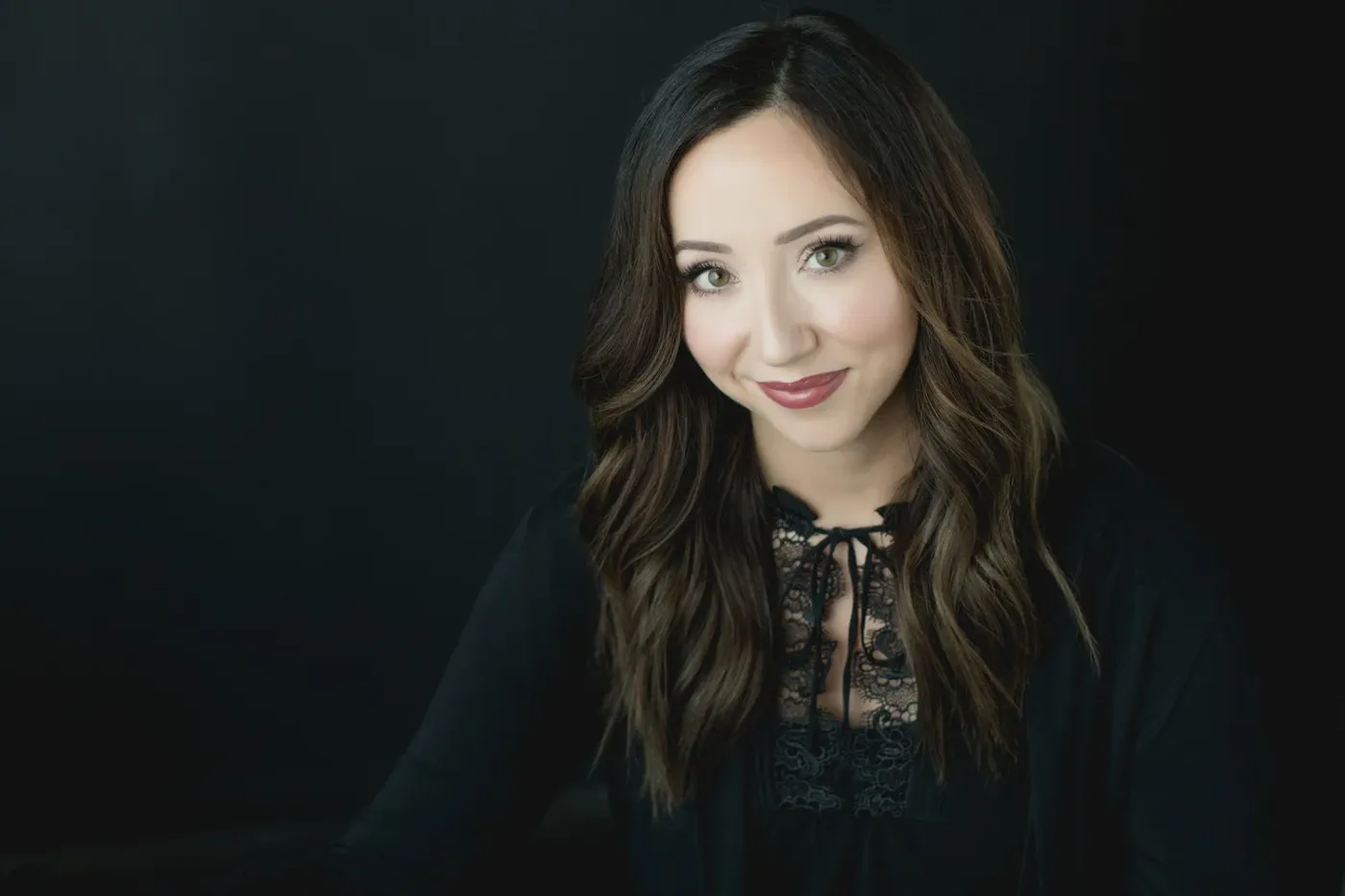 Studio headshot on a dark backdrop